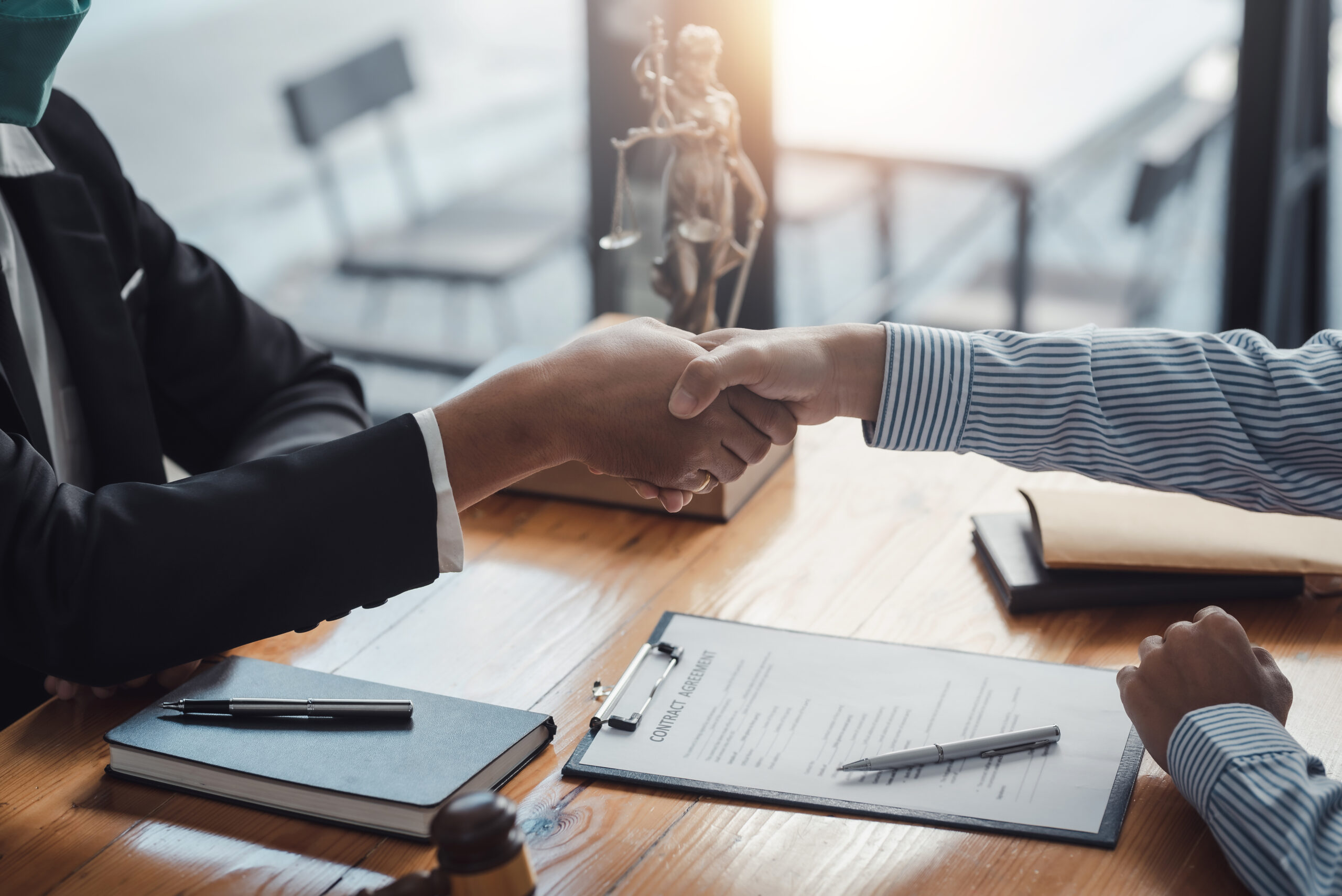 Businessman shaking hands partner lawyers or attorneys discussin